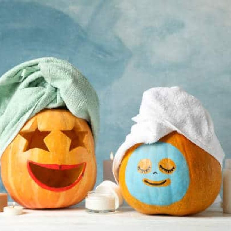 Funny pumpkins and skin care accessories on white background, copy space